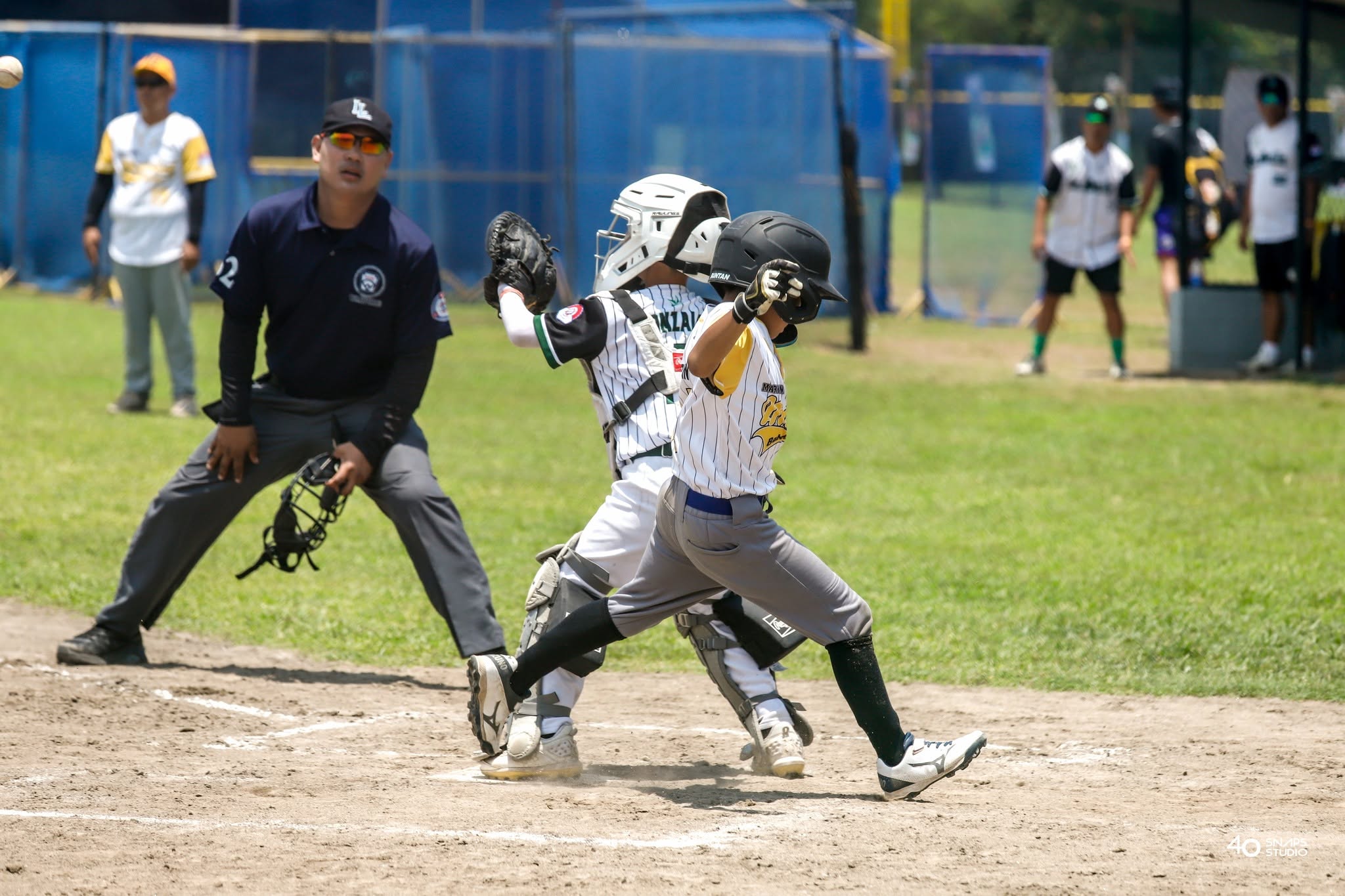 Young baseball batter and catcher during a game
